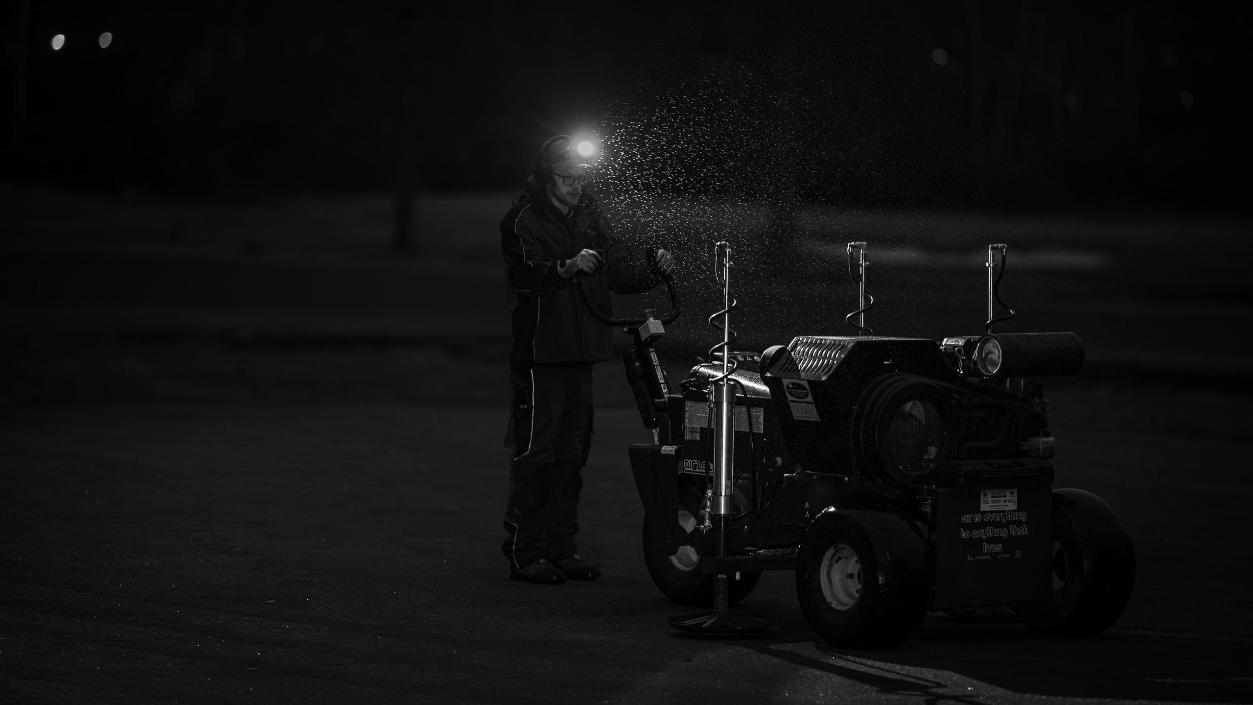 Greenkeeper operating the AIR2G2 by head torch on the 8th green