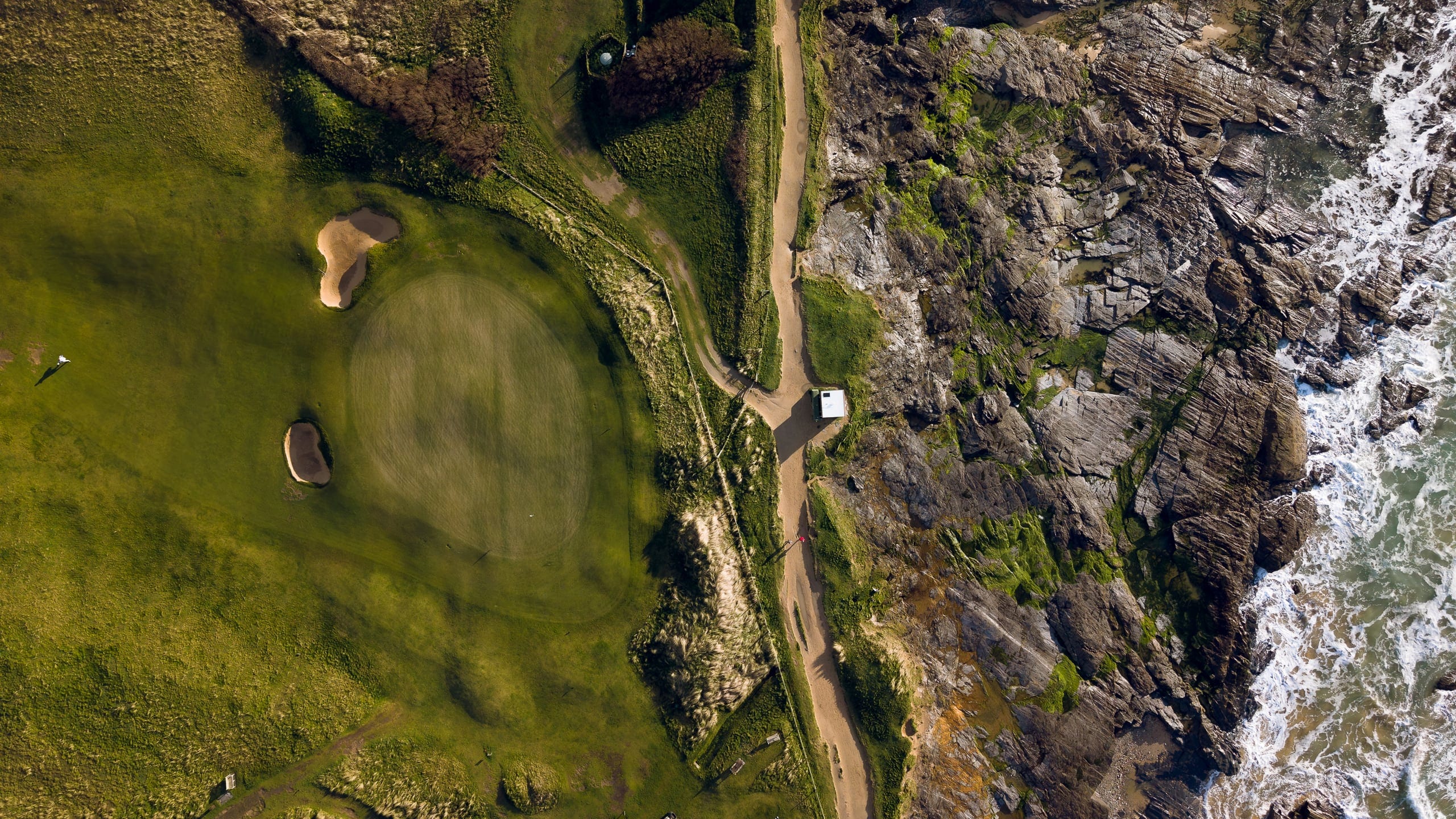 Aerial view of a clifftop green at Trevose above the rocks